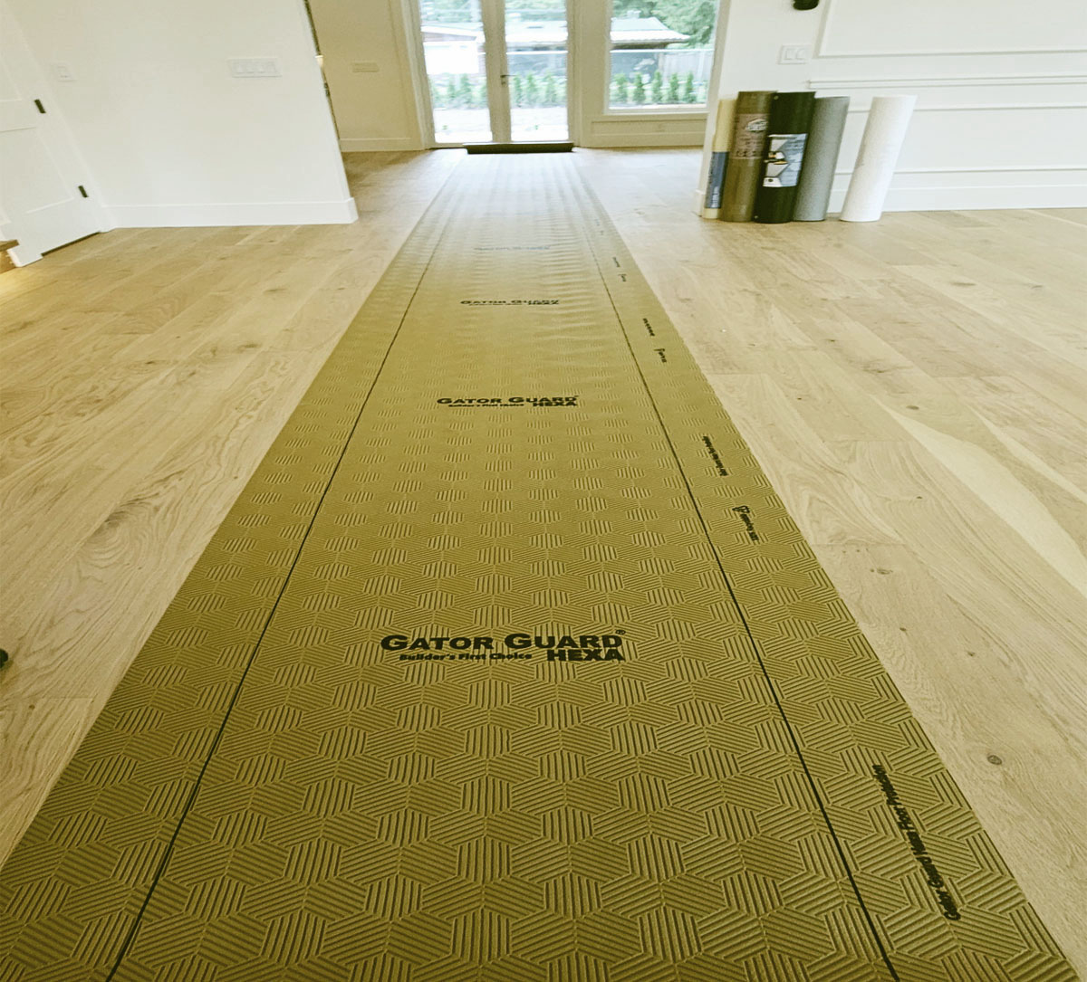 Gator Guard Gold floor protection roll laid flat on hardwood floor, showing full surface coverage